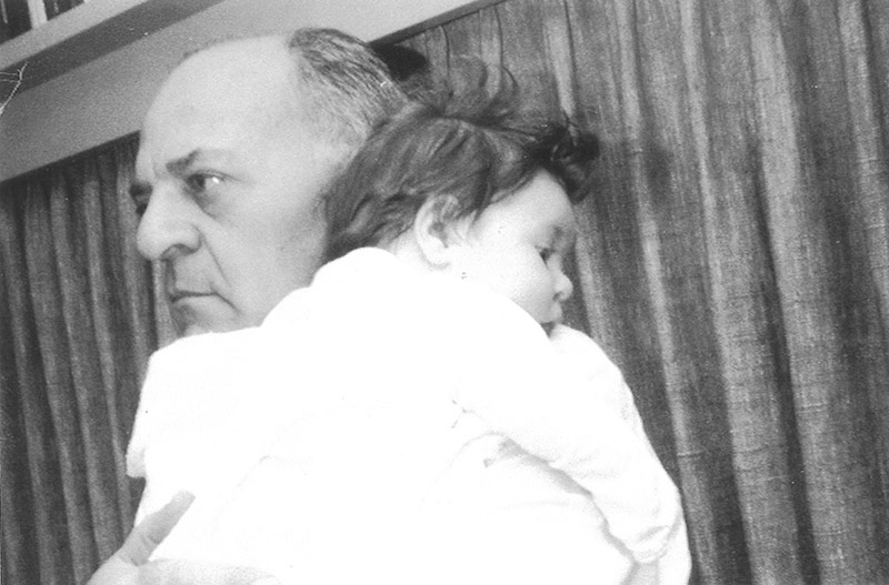an old black and white image of Margo as a baby being held by her father as she rests her head on his shoulder
