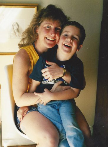 an image of Margo holding her son Jimmy on her lap when he was a small boy around 5 years old.