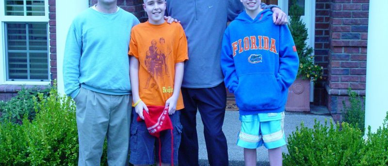 Dan in light blue pullover, Jimmy in orange shirt, Robin in light navy pullover and Willie in Florida Gators sweatshirt, all bald