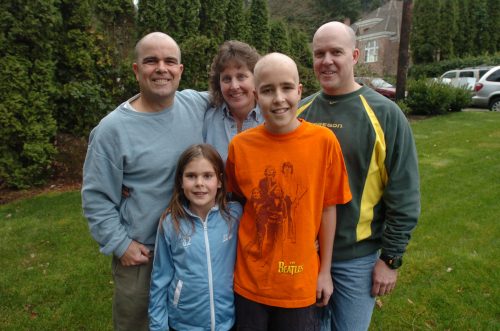 Taken at Jimmy's head shaving party. Dan, on the left, is bald and wearing a blue shirt. Margo is also wearing a blue shirt and is standing next to him. Chris is next to Margo. He's also bald and is wearing a green and yellow Nike pullover. Molly and Jimmy are in the front. Molly is wearing a blue jacket and Jimmy is wearing an orange shirt.
