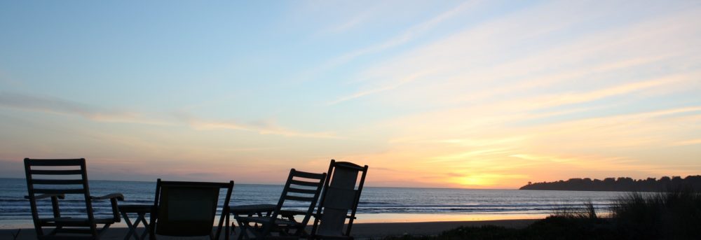 Deck chair arranged in a circle against the backdrop of a sunset