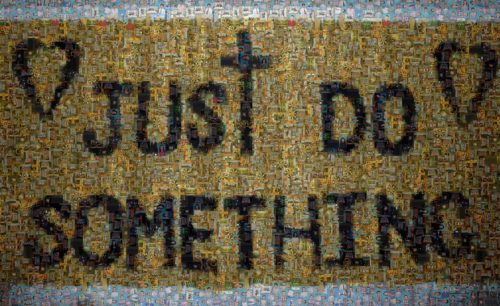 "Just Do Something" written in black paint on top of pictures of people. The photos are brown in tone.